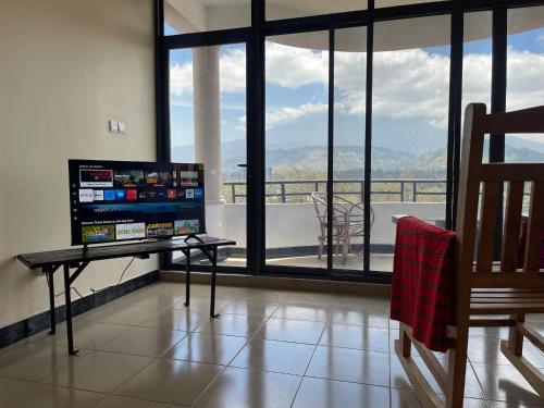 a living room with a view of a balcony at CITY Que2ens in Arusha