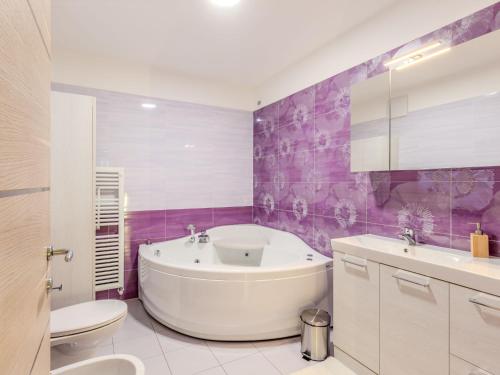 a bathroom with a tub and a toilet and a sink at Apartment Elisa by Interhome in Ronzone
