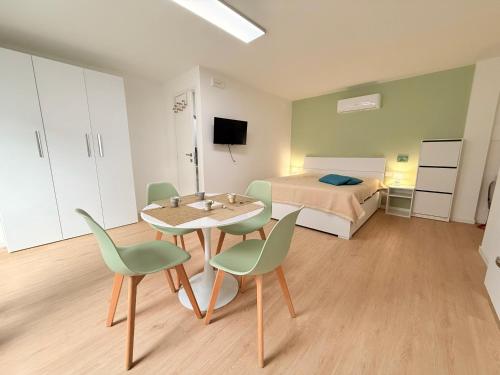 a room with a bed and a table and chairs at Ella vacanze in Grottammare