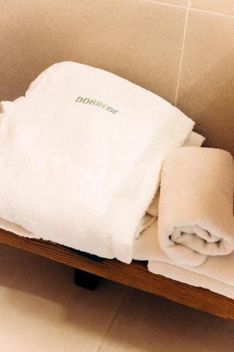 a pile of towels sitting on a shelf at Dobrede - будиночки під лісом in Dubrynychi