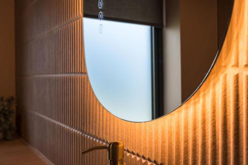 a bathroom with a mirror and a sink at Du Cabana By Birch Stays in Rhosneigr