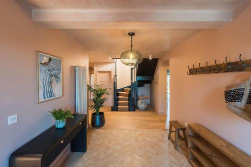 a hallway with a staircase in a house at Du Cabana By Birch Stays in Rhosneigr
