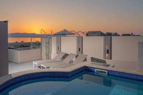 a swimming pool with lounge chairs and a swimming pool at Villa Miami in Agia Marina Nea Kydonias