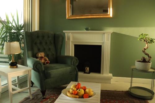 a teddy bear sitting in a chair in a living room at Domus Aurus Luxury in Bardolino