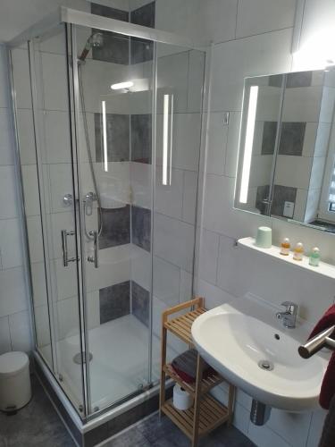 a bathroom with a shower and a sink at Pension Tiffany in Chemnitz