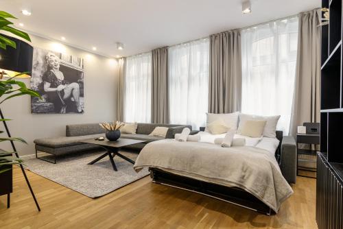 a bedroom with a large bed and a couch at ELLY NINE - stylish urban apartments in Wiesbaden
