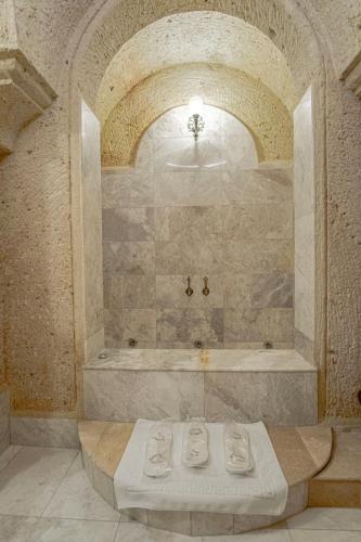 a large bathroom with a shower with a tub at Kemerhan Cave Suites in Urgup