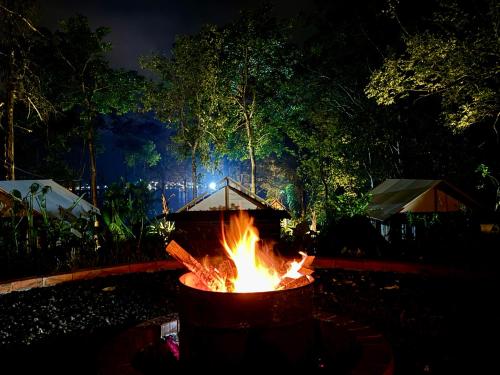 a fire pit in a yard at night at Green Lava Lake View Glamping Bedugul By IHM in Bedugul