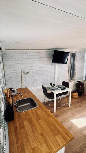 a kitchen with a sink and a table and a desk at Sunset View in Arona