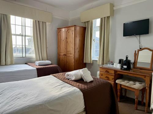a hotel room with two beds and a television at The Crescent York in York