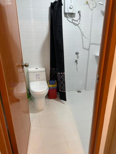 a bathroom with a toilet and a shower at Jpmb Transient Homes in Baguio