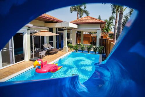 a pool in a house with a plastic inflatablelatable dstg at King Family Massarossa Pool Villa Pattaya VIP in Pattaya
