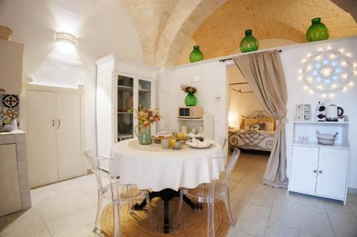 a kitchen with a table with a white table cloth at Un giorno bellissimo suite & spa in Martina Franca