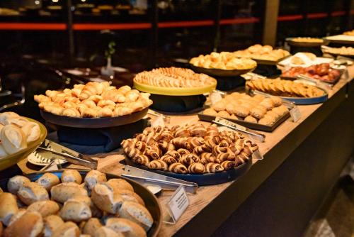 a buffet with many different types of food on a table at Royal Tulip Brasília Alvorada in Brasilia
