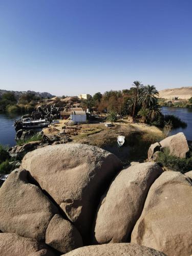 a group of large rocks in the middle of a river at Hannag Island in Aswan
