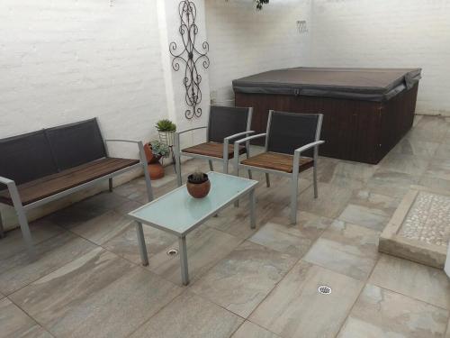a living room with two chairs and a bed at The Lookout, 195 Bester Street, Clarens in Clarens