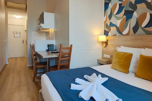 a hotel room with a bed with two towels on it at Aparthotel AMMI Nice Massena - ex Ajoupa in Nice