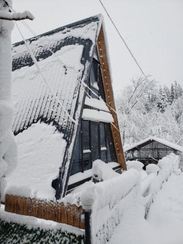 a house covered in snow with at Cottage "Sunset" in Batumi