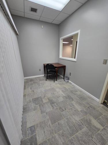 an empty room with a table and a chair at Spooky Nook Bed and Breakfast in Manheim