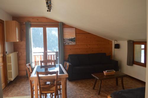 un salon avec un canapé et une table dans l'établissement La Loulettaz, au Grand-Bornand