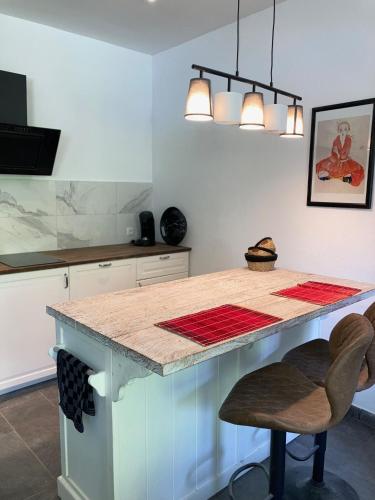 a kitchen with a counter with a island in it at Ferienwohnung Studio Seebrauer In Feld Am See in Feld am See