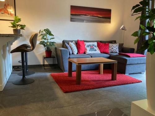 a living room with a couch and a coffee table at Ferienwohnung Studio Seebrauer In Feld Am See in Feld am See