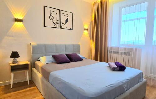 a bedroom with two beds and a window at Arman 2 in Kokshetau