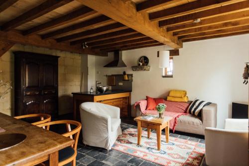 a living room with a couch and a table at De Zwarte Stok in Riemst