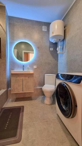 a bathroom with a washing machine and a toilet at Arman 2 in Kokshetau