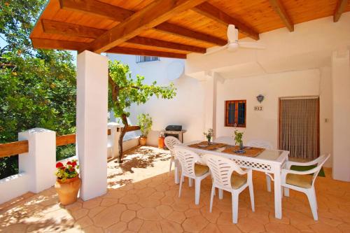 ein Esszimmer mit einem Tisch und Stühlen auf einer Terrasse in der Unterkunft Ferienhaus für 6 Personen ca 124 qm in Comares, Andalusien Costa del Sol in Comares