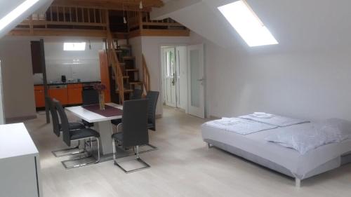 a bedroom with a bed and a table and chairs at Studio Für 4 Personen Ca 106 M Sup2 In Gozd, Krain Innerkrain in Gozd