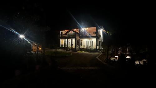 a house at night with lights in front of it at Lotus Exotica Homestay in Suntikoppa