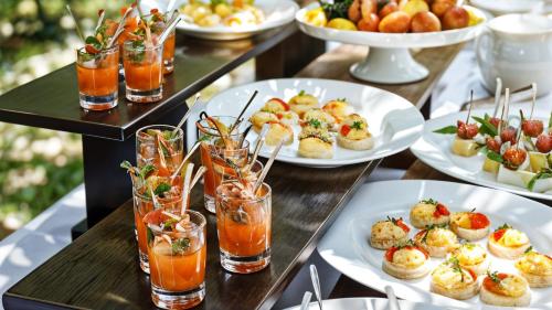 a table topped with plates of food and drinks at Crowne Plaza Kochi by IHG in Cochin