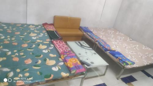 a room with two beds and a box at King Kabir Resort in Badlapur