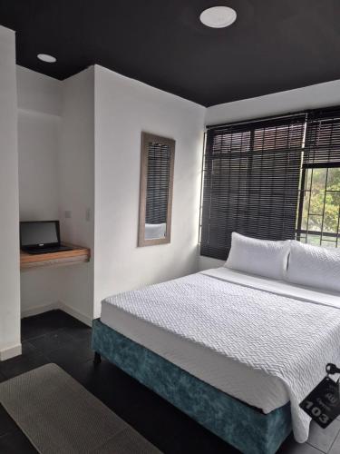 a bedroom with a large bed and a window at Hotel Capital HEU in Bogotá