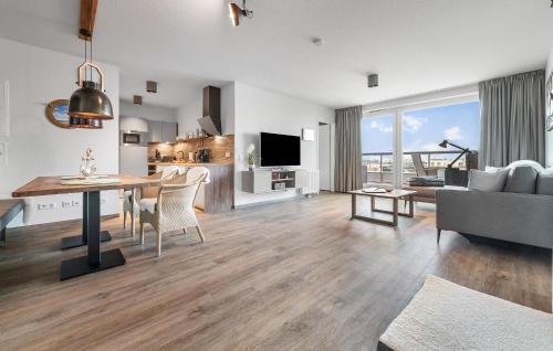 a living room with a dining table and a couch at Slessmynna in Kappeln