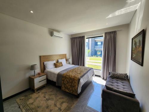 a hotel room with a bed and a window at Starlight Haven in Gaborone