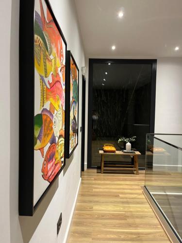 a hallway with paintings on the walls of a house at Villa Essencia in Zahara de los Atunes