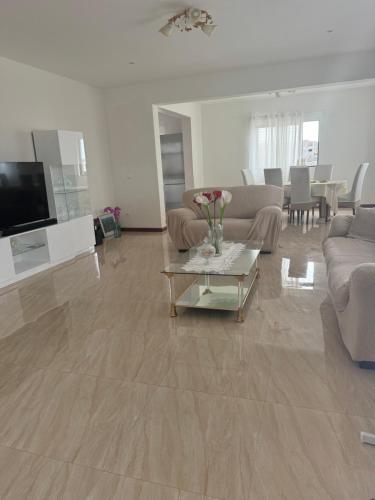 a living room with a couch and a table at Casa Carveiros Panoramic 360 in Tarrafal