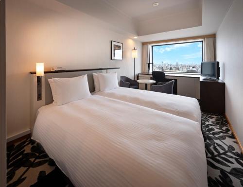 Postel nebo postele na pokoji v ubytování ANA Crowne Plaza Hotel Grand Court Nagoya by IHG