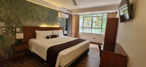 Postel nebo postele na pokoji v ubytování Hotel Ferré Machu Picchu