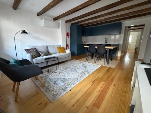 a living room with a couch and a table at Egas Duplex Historic Centre in Guimarães