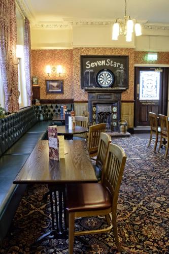 a restaurant with a table and chairs and a clock at The Seven Stars in Stourbridge