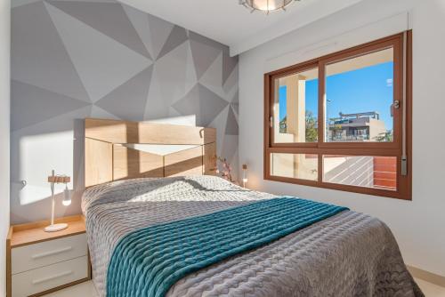 a bedroom with a bed and a window at Michael in Torre de la Horadada