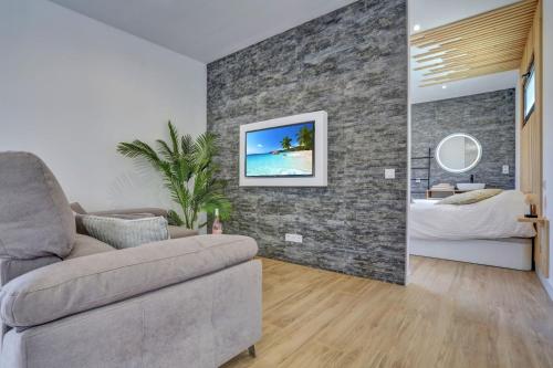 a living room with a couch and a bedroom at ISLAND WEEK Fuerteventura in La Oliva