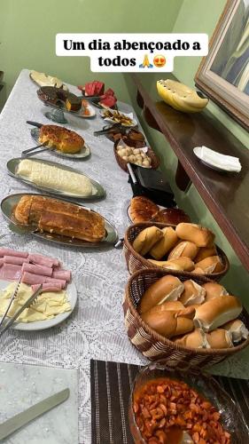 a long table with plates of food on it at Pousada do Deck in Alcobaça