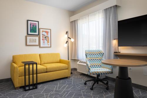 a living room with a yellow couch and a table at Hampton Inn & Suites Cottonwood, Az in Cottonwood