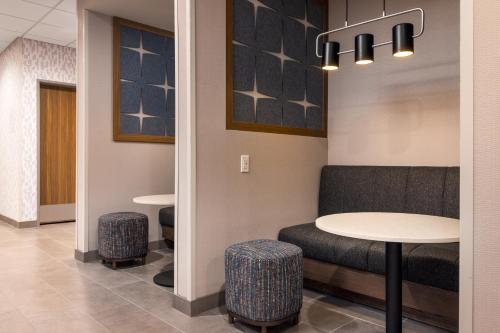 a waiting room with a table and stools at Hampton Inn & Suites Cottonwood, Az in Cottonwood