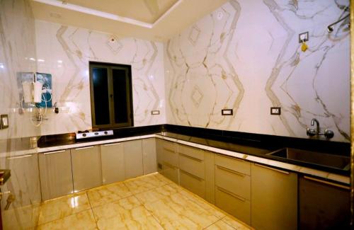a kitchen with a counter and a sink in a room at Kutumbakam Natural Retreat in Eklingji