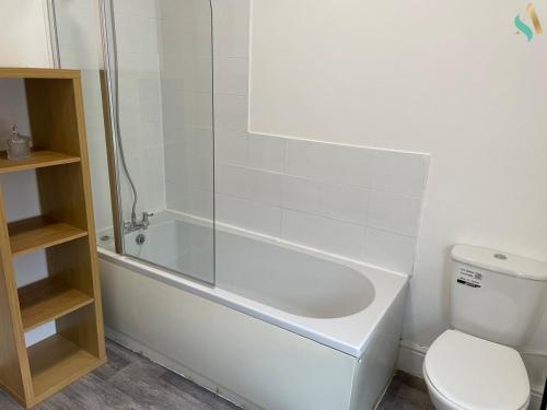 a bathroom with a tub and a toilet and a shower at Firwood House in Ferryhill